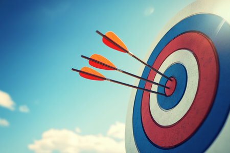 Arrows striking the bullseye against a bright blue sky, symbolizing business success and achievementの写真素材