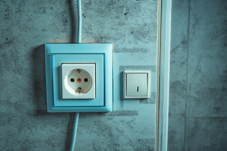 Installation of new electrical cable and arena light switch in bathroom by professional electricianの写真素材