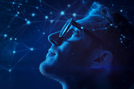 A man in glasses envisions futuristic technology with glowing connections on a dark background