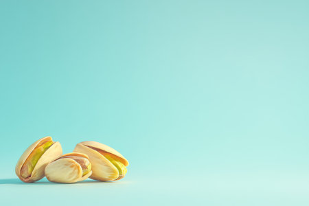 Elegant pistachio nuts on a light blue gradient background with ample copy space for branding.の写真素材