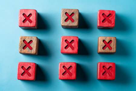 Minimalistic flat lay of red wooden blocks with check marks and xs on blue background for marketingの写真素材