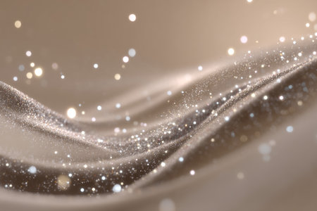 Surreal beige gradient background with glitter dust, swirls, and glowing particles for design useの写真素材