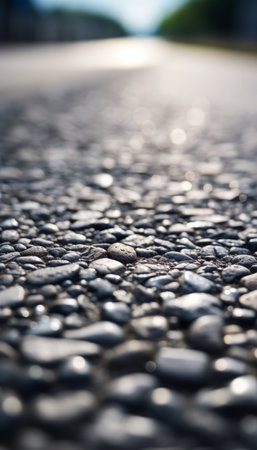 Low angle close up of a newly paved road with defined centerline and surrounding foliageの写真素材
