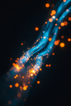 Vibrant blue and orange glowing fiber optic cable illustrating high speed communication technologyの写真素材