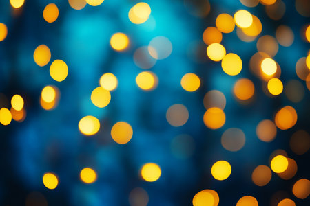 Abstract blurred background featuring yellow bokeh lights on a blue canvas for celebratory eventsの写真素材