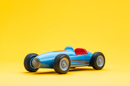 Vintage toy car on yellow background blue and red striped model racing vehicle for childrenの写真素材