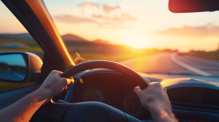 Sunset road trip hands of driver on steering wheel in high quality summer drive photoの写真素材