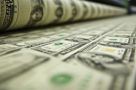 Close up of freshly printed us dollar bills illustrating inflation and the money printing processの写真素材