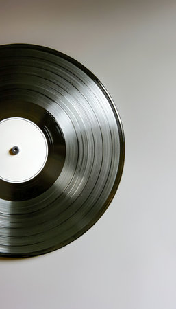 A detailed shot of a glossy black vinyl disc spinning on a vintage turntable, evoking nostalgia and perfect for music, retro, or audio themes.の写真素材