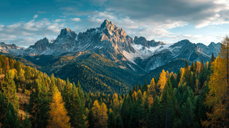 Towering peaks amid dense greenery and vibrant fall foliage evoke serenity and grandeur, perfect for nature, adventure, or travel themes.の写真素材