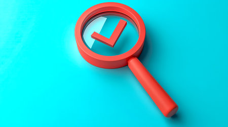 A close-up of a magnifying glass featuring a green check mark, set against a lively blue backdrop, conveying accuracy, verification, and precision.の写真素材