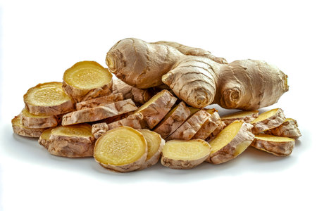 Vibrant whole ginger with freshly sliced pieces displays its knobby texture and rich color, perfect for culinary and health-related uses on a pristineの写真素材
