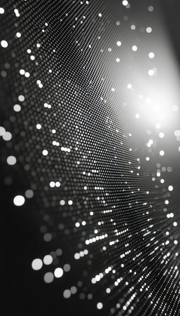 A mesmerizing swirl of luminous digital particles dances in a dark, monochrome space, creating a dynamic and futuristic visual aura.の写真素材