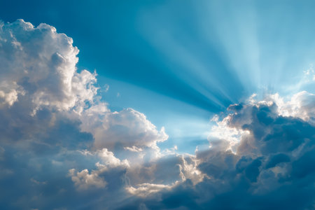 Warm sunlight filters through wispy clouds, illuminating the vibrant azure sky and creating a serene, uplifting atmosphere perfect for outdoor or inspの写真素材