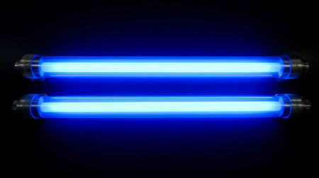 Vibrant blue ultraviolet tubes emit an eerie glow against a dark backdrop, creating a futuristic, mysterious atmosphere ideal for sci-fi or nightlifeの写真素材