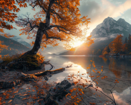 Magnificent view of the autumn sunset reflecting on hintersee lake on a clear and sunny dayの写真素材