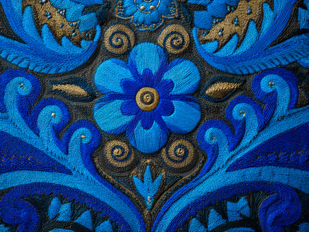 Delicate azure stitches form elaborate floral motifs highlighted with shimmering gold accents and...