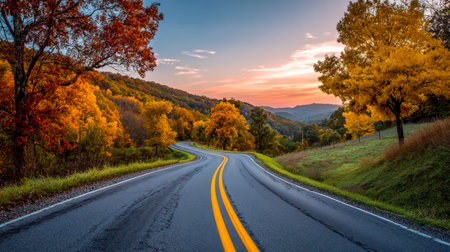A tranquil mountain pathway snakes through a vibrant fall scene, illuminated by the warm glow of...