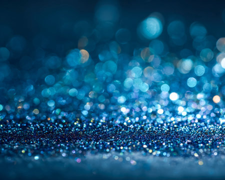 A vibrant cascade of shimmering cobalt blue particles overlays a dreamy, softly blurred light...