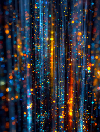 Dynamic swirling patterns of luminous blue, orange, and yellow spheres create a captivating,...
