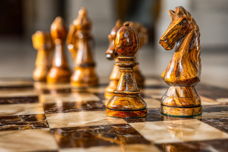 An elegant display of meticulously carved wooden figures poised on a glaming chess surface,...