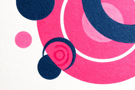 A vivid array of pink and navy blue shapes an intricate circular design, set against a textured...