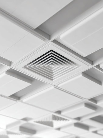 A sleek, contemporary ceiling featuring crisp white panels arranged in geometric patterns,...