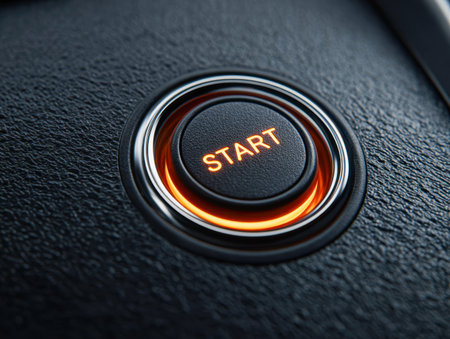 A sleek, dark control panel highlights a luminous button, its orange glow encircling a bold...