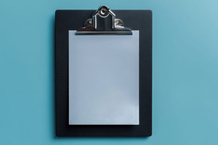 A pristine white page attaches firmly to a sleek black clipboard, set against a gentle blue...