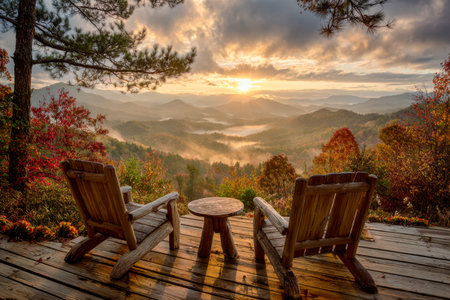 Paired wooden seats rest on an aged deck, gazing towards a lush forest bursting with fall colors,...