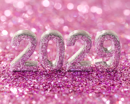 Elegant pink numerals shimmer with glitter against a radiant, sparkling backdrop, evoking celebration and futurism for diverse creative projects.の写真素材