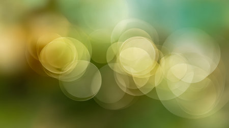 Gentle, luminous orbs in shades of yellow and green soften into a blurred backdrop, evoking a serene, mystical atmosphere inspired by nature?s abstract beauty.の写真素材