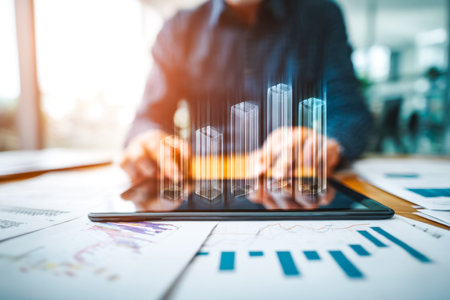 A focused executive reviews numerical insights on a sleek device, complemented by vibrant digital...