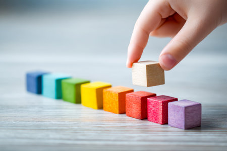 Close-up of a hand stacking a wooden block atop a vibrant, rising bar chart, symbolizing strategic...