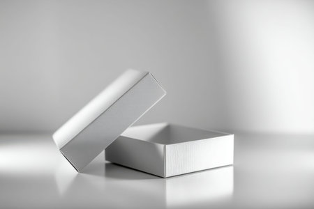 A sleek, pristine white box with a gently ajar lid rests on a glossy surface, highlighting subtle...