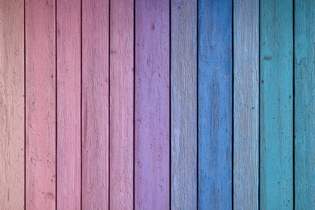 A striking array of vertically aligned wooden planks showcases a seamless color shift, moving from delicate pinks to serene purples, blues, and teals, evoking tranquilityの写真素材