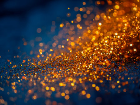 Sparkling gold flecks scatter across a deep matte surface, producing enchanting bokeh and vivid, luminous effects that evoke a sense of wonder and celebration.の写真素材