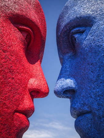 Two stone vibrant figures, one fiery red and the other cool blue, stand opposing under a bright sky, embodying themes of conflict and harmony in minimalist form.の写真素材