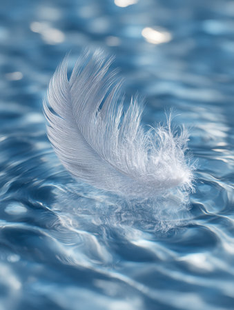A fragile white plume drifts serenely atop tranquil azure waves, with subtle sunlight glinting softly on the gentle undulations of the surface.の写真素材