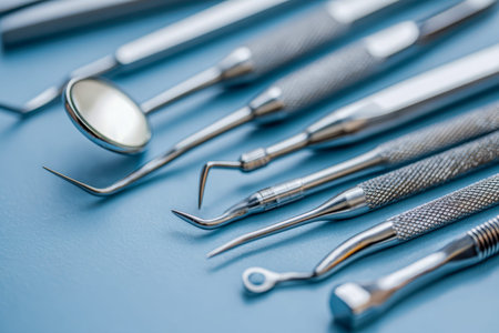 A carefully organized collection of clinical-grade metallic dental instruments displayed neatly on a...