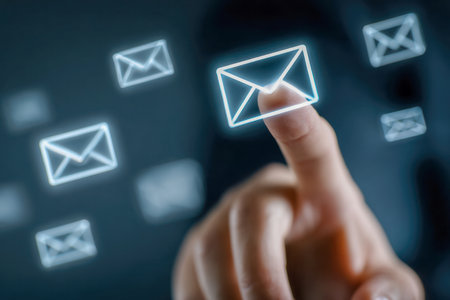 An individual reaches out amidst a swarm of luminous digital mail symbols in a futuristic space, highlighting innovations in communication and electronic messaging.の写真素材