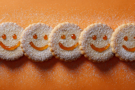 Cheerful treats featuring a neat sequence of smiling cookies filled with jam and lightly coated in...