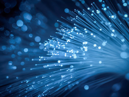 Vibrant blue streams of light pulse along sleek cables, their glow diffusing into a blurred backdrop, evoking a sense of advanced connectivity and rapid digital flowの写真素材