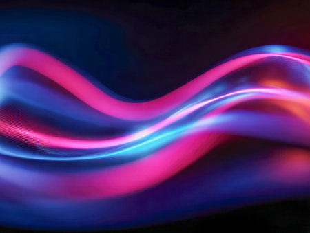 Dynamic luminous streaks ripple gracefully across a shadowed backdrop, blending vivid pink and blue tones to evoke a sleek, cutting-edge digital energy.の写真素材