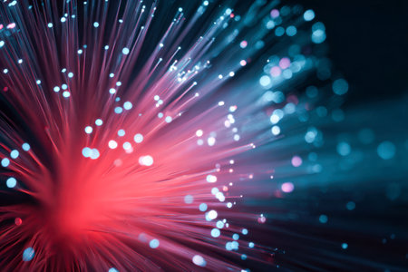Electric crimson and azure filaments intertwine, radiating luminous brilliance against a soft, blurred backdrop, capturing the essence of cutting-edge digital connectivitの写真素材