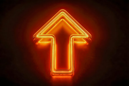 A sleek, vibrant orange neon arrow ascends sharply against a dark backdrop, reflecting dynamic energy and guiding pathways toward future growth.の写真素材
