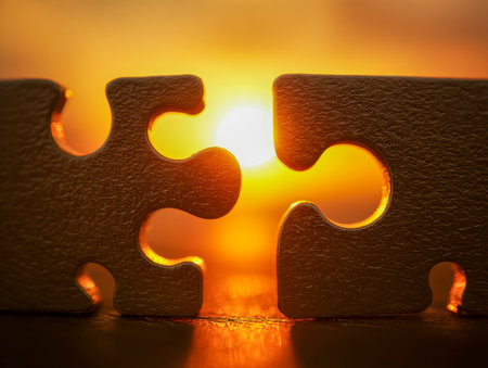 A pair of fitting puzzle fragments glow softly in the warm hues of dusk, representing harmony, the power of unity, and the fulfillment of a special connection.の写真素材