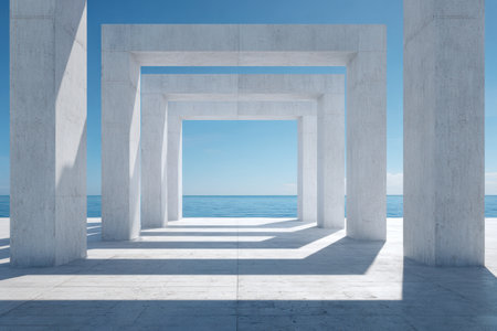 A sleek concrete design featuring sharp geometric cutouts, casting intricate shadows against a tranquil seascape under a vivid azure sky.の写真素材
