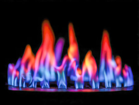 An energetic display of swirling blue and orange flames dances against a midnight backdrop, evoking vitality and cozy intensity in a bold abstract form.の写真素材