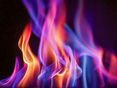 Swirling flames in vivid purples, royal blues, and fiery oranges ignite against a shadowy backdrop, crafting an entrancing and energetic tableau of combustion art.の写真素材